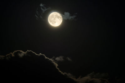 Low angle view of moon against sky at night