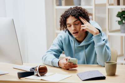 Young woman using laptop at table