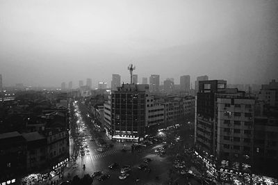 Illuminated cityscape against sky at night