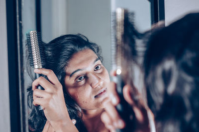 Portrait of woman looking through window