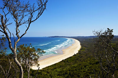 Scenic view of tallow beach against blue sky