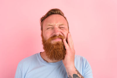 Portrait of man wearing mask against gray background