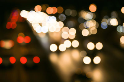 Defocused image of illuminated christmas lights at night