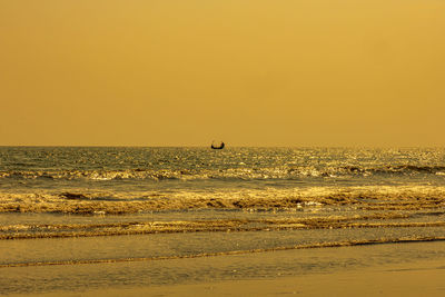 Scenic view of sea against clear sky during sunset