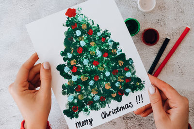 Diy making greeting card handmade crafts on holiday for children. paint with fingers merry christmas