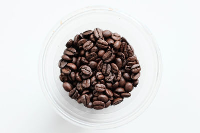 High angle view of coffee beans on white background