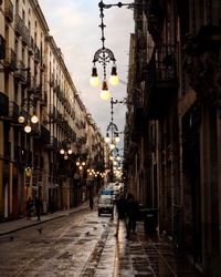 People walking on street amidst buildings in city