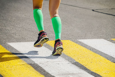 Low section of man walking on street