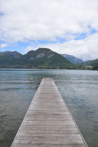 Pier over lake against sky