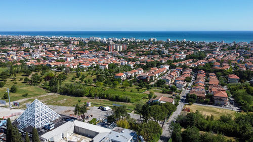 High angle view of townscape by sea against sky