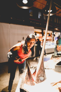 Portrait of woman standing by swordfish