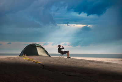 Man on beach against sky