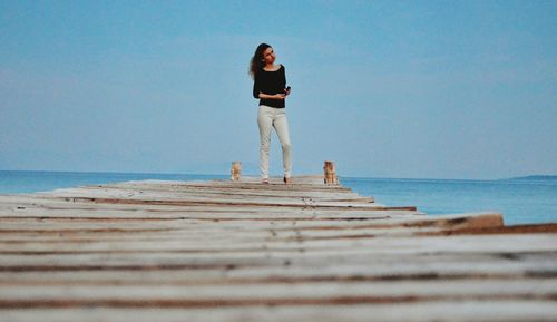 Man standing on beach against clear sky