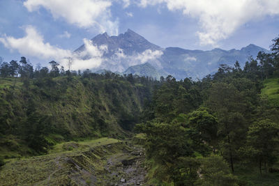 Merapi volcano view from kalitalang, yogyakarta, indonesia. scenic view of mountains against sky