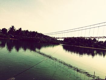 Bridge over river against clear sky