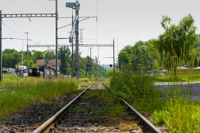 Railroad track amidst trees against clear sky