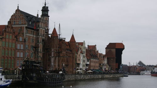 Boats in river with buildings in background