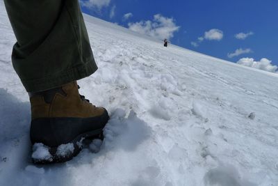 Low angle view of the foot of a hiker in winter