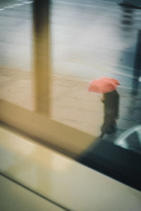 Rear view of woman with umbrella on street
