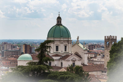 Buildings in city against sky