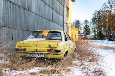 Yellow car on snow covered landscape