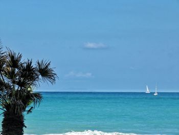 Scenic view of sea against blue sky