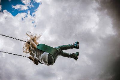 Girl on a swing on a cloudy day