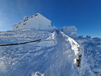 Scenic view of snowcapped mountains against clear blue sky