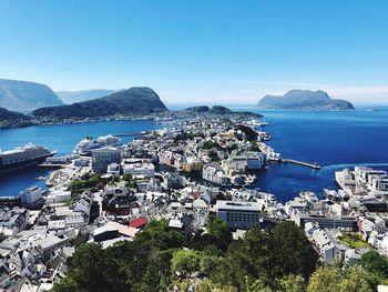 High angle view of city by sea against sky