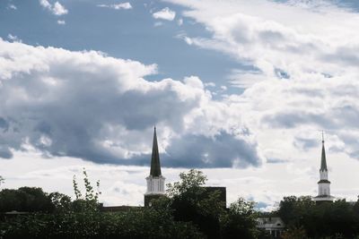 Buildings against cloudy sky