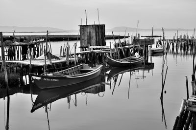 Boats moored in sea against sky