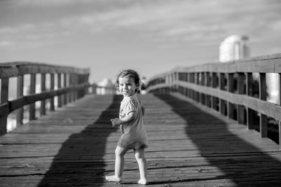 Portrait of cute child walking on footbridge