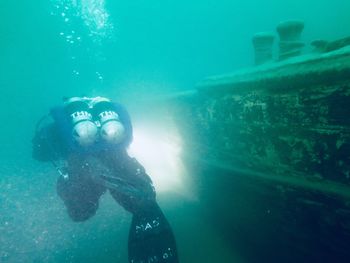 Scuba diver by wrecked ship