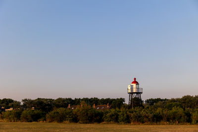 A beautiful white and red lighthouse on the north sea coast in the netherlands.