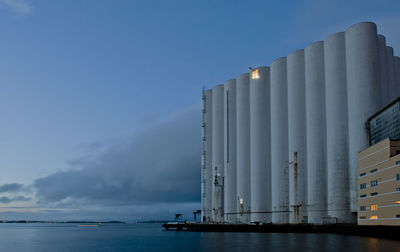 Panoramic view of silo and  sea against sky at dusk