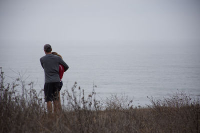 Rear view of woman standing in water
