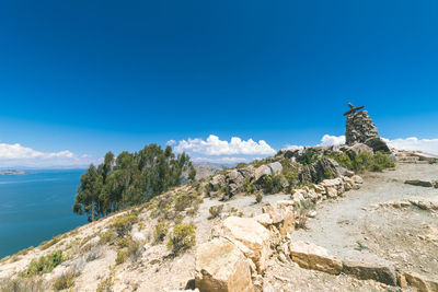 Scenic view of beach against blue sky