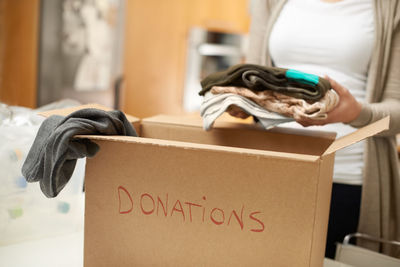 Rear view of woman holding box