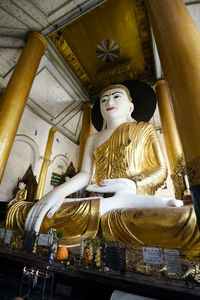 Low angle view of statue against temple building