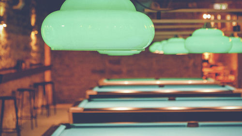 Close-up of pendant lights above pool tables