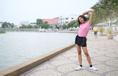 Full length teenage girl standing on footpath