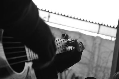 Cropped image of person playing guitar