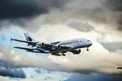 Low angle view of airplane flying in sky