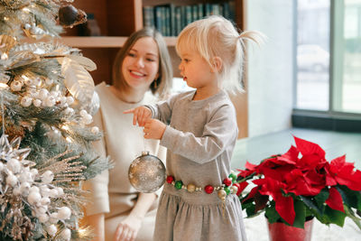 Rear view of girl and christmas tree