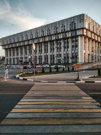 Road by building against sky in city