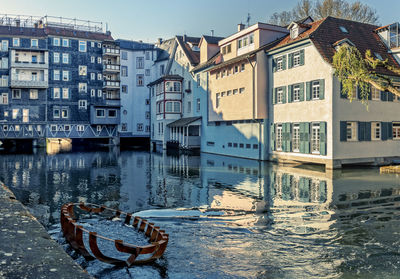 Buildings by canal in city