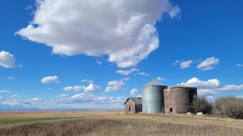 Barn on field against sky