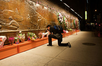 Full length of man sitting on floor