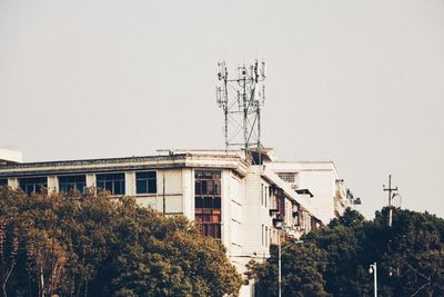 Low angle view of electricity pylon against clear sky