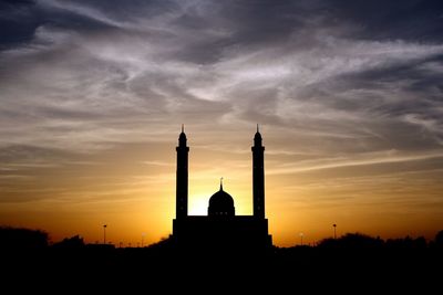 Silhouette of building against sky during sunset